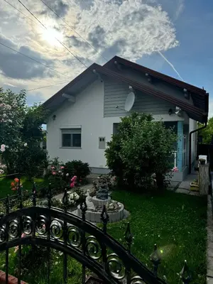 a house with a fence in front of a yard at Apartment Deluxe Holiday in Bihać