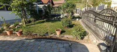 a garden with potted plants next to a fence at Apartment Deluxe Holiday in Bihać