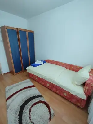 a bedroom with a bed and a rug at Apartman Unac in Drvar