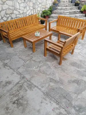 two wooden benches sitting on a stone patio at Apartman Unac in Drvar