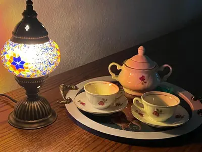 a table with two tea cups and a lamp at Apartment Old Town Visoko in Visoko