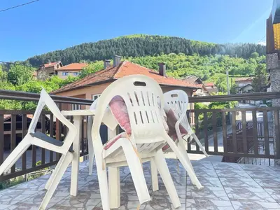two white plastic chairs sitting on a balcony at Apartment Old Town Visoko in Visoko