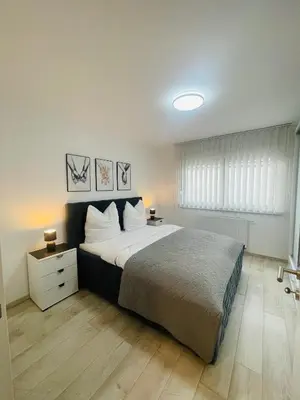 a bedroom with a large bed in a room at Happy Dreams Oasis Cazin, Modernes Apartment 60m2, WiFi & Balkon in Cazin