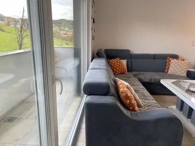 a living room with a couch and a window at Happy Dreams Oasis Cazin, Modernes Apartment 60m2, WiFi & Balkon in Cazin
