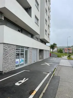 an empty parking lot in front of a building at Happy Dreams Oasis Cazin, Modernes Apartment 60m2, WiFi & Balkon in Cazin