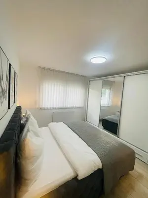 a bedroom with a large bed and a mirror at Happy Dreams Oasis Cazin, Modernes Apartment 60m2, WiFi & Balkon in Cazin