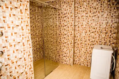 a bathroom with a glass shower with a toilet at Lux Villa Emina in Tuzla