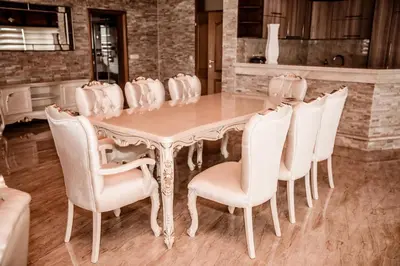 a dining room table with white chairs around it at Lux Villa Emina in Tuzla