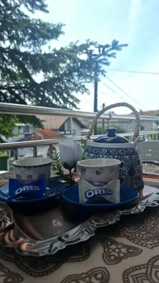 a table with a tea pot and three dishes on it at Apartman Nani in Bihać