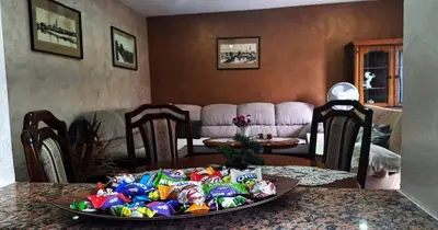 a table with a plate of candy on a table at Apartman Nani in Bihać