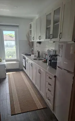 a kitchen with a white refrigerator and a sink at Apartman Nani in Bihać