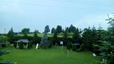 a yard with a gazebo and trees at Resort Čokori in Banja Luka
