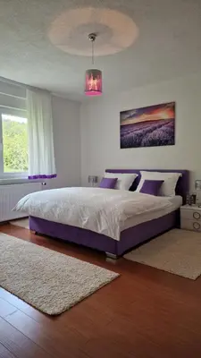 a bedroom with a large bed with purple pillows at Holiday Home Gredina in Livno