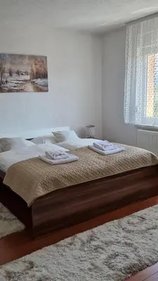 a bedroom with a large bed with two towels on it at Holiday Home Gredina in Livno