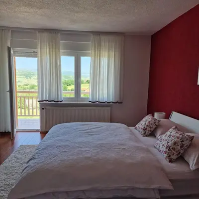 a bedroom with a large bed and a large window at Holiday Home Gredina in Livno