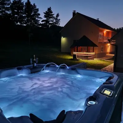 a jacuzzi tub in a yard at night at Holiday Home Gredina in Livno