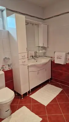 a bathroom with a white sink and a toilet at Holiday Home Gredina in Livno