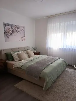 a bedroom with a large bed and a window at Apartman Centar in Modriča