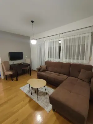 a living room with a couch and a table at Apartman Amabilis in Banja Luka