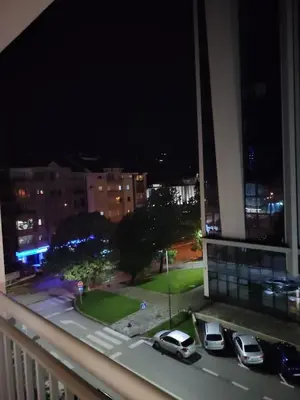 a view of a parking lot at night from a balcony at Apartman Amabilis in Banja Luka