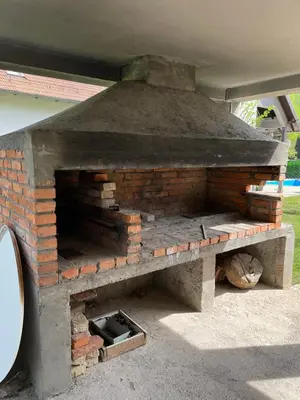 a brick oven with a cat laying on the ground at 069 Riverside Vikendica - Banja Luka in Rekavice