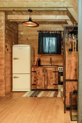 a kitchen with a white refrigerator and wooden cabinets at Village house Iva in Livno