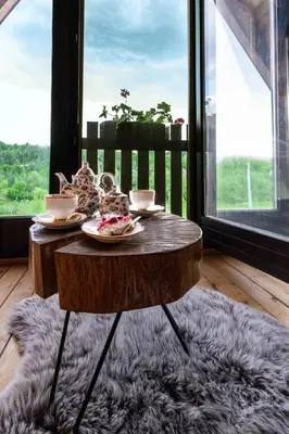 a wooden table with plates of food on it in front of a window at Village house Iva in Livno