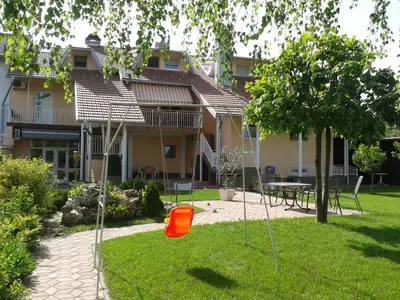 a yard with a playground with an orange bucket at Apartman River in Prijedor
