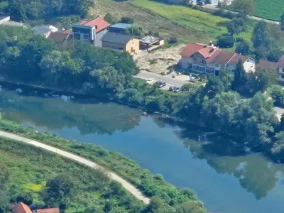 an aerial view of a house next to a river at Apartman River in Prijedor