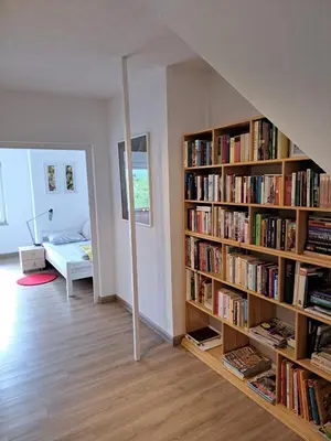 a room with a book shelf filled with books at Apartman River in Prijedor