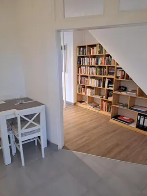 a room with a desk and a book shelf with books at Apartman River in Prijedor