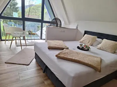 a bedroom with a bed with a plate of food on it at Oaza mira 1 in Jajce