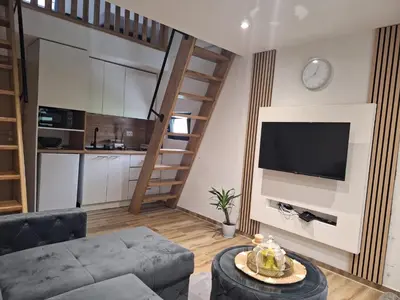a living room with a couch and a flat screen tv at Oaza mira 1 in Jajce