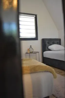 a bedroom with two beds and a window at Oaza mira 1 in Jajce