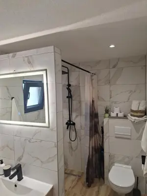 a bathroom with a shower and a toilet and a sink at Oaza mira 1 in Jajce