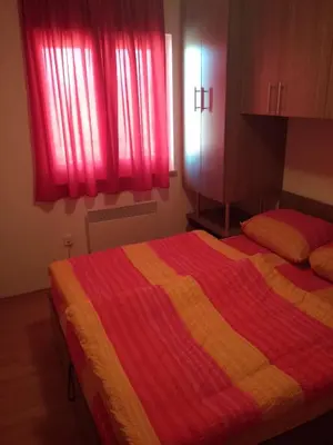 a bedroom with a bed with a colorful blanket at Apartment Kupres in Kupres