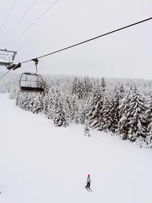 a person riding a ski lift on a snow covered slope at Apartment Kupres in Kupres