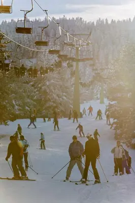 a group of people skiing on a ski lift at Apartment Kupres in Kupres