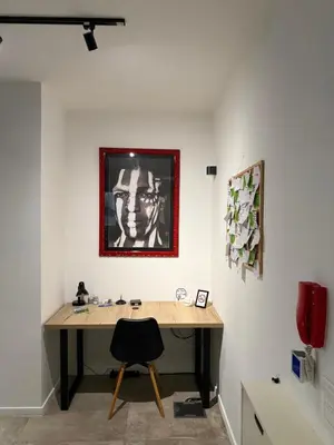 a desk in a room with a picture on the wall at Alex apartment in Banja Luka