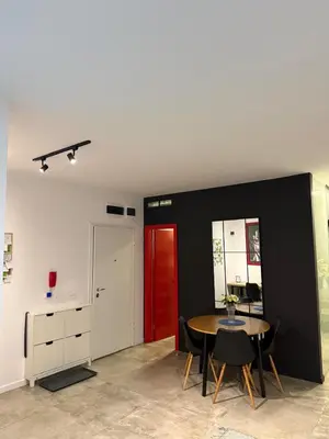 a dining room with a table and a red door at Alex apartment in Banja Luka