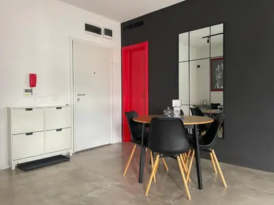a dining room with a table and a red door at Alex apartment in Banja Luka