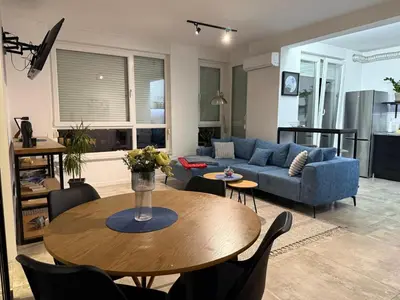 a living room with a table and a blue couch at Alex apartment in Banja Luka