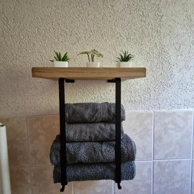 a table with four towels and two potted plants on it at Family Apartment Miki in Teslic in Teslić
