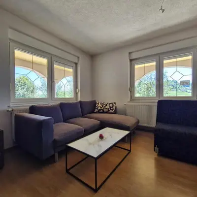 a living room with a couch and a coffee table at Family Apartment Miki in Teslic in Teslić