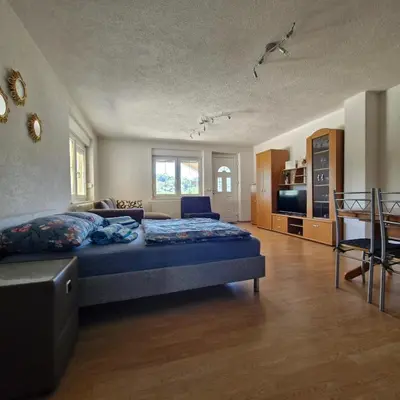 a large bedroom with a bed and a couch at Family Apartment Miki in Teslic in Teslić