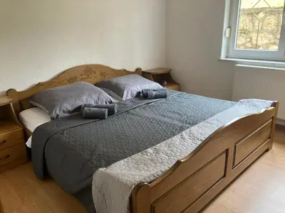 a bedroom with a large bed with two pillows at Family Apartment Miki in Teslic in Teslić