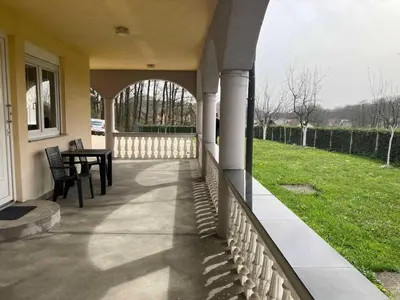 a porch of a house with a table and chairs at Family Apartment Miki in Teslic in Teslić