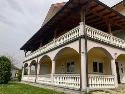 a large white house with a large balcony at Family Apartment Miki in Teslic in Teslić