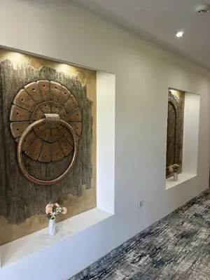 a painting on a wall with a vase with flowers at Hotel Residence Travnik in Travnik