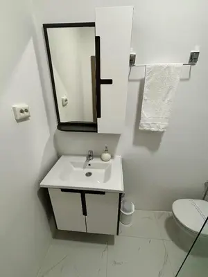 a bathroom with a sink and a mirror and a toilet at Hotel Residence Travnik in Travnik